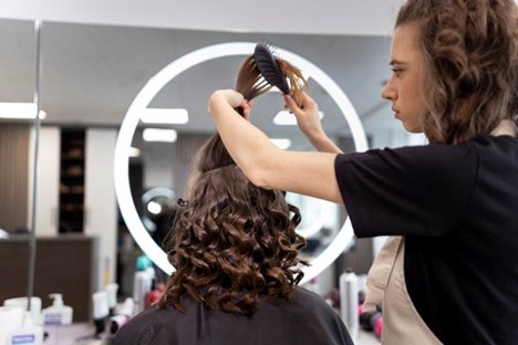 Hairdresser taking care of her client.