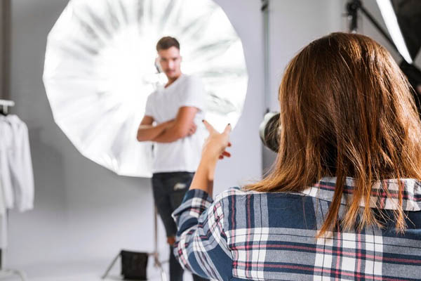 Woman taking photos handsome model