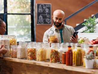 Arab man uses cell phone for eco products. Top 3 places to make the pantry in Istanbul, Turkey