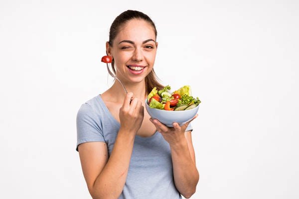 woman-smiling-holding-salad