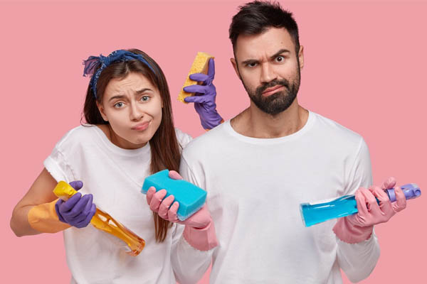 young-couple-holding-cleaning-products