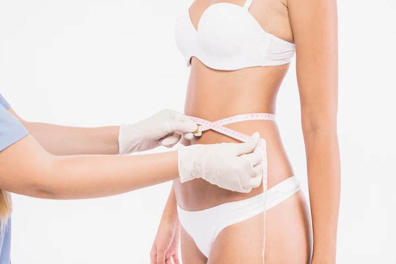 doctor-measuring-waist-woman