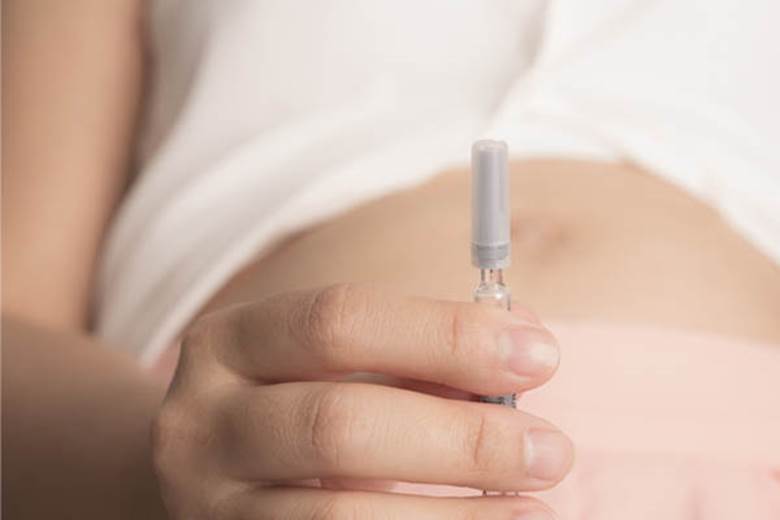 close-up-woman-holding-injection