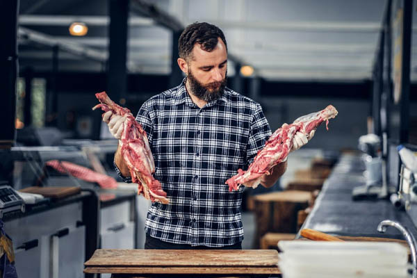 butcher-bearded-dressed-fleece-shirt-working-butcher shop